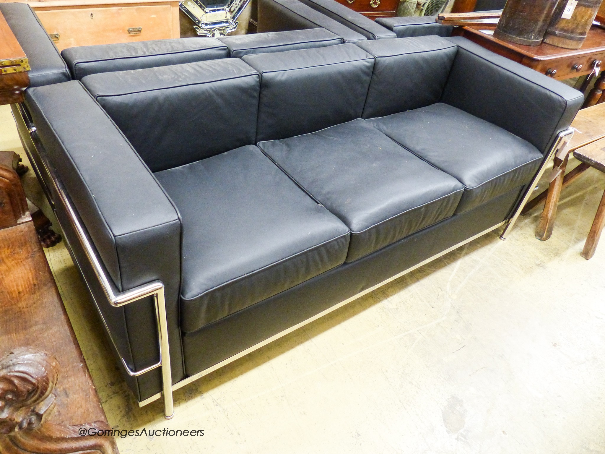 A Corbusier style chrome and black leather three seater sofa, length 180cm, depth 68cm, height 69cm